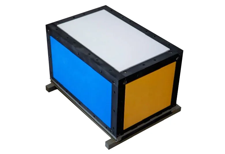 The TDO-2 satellite, a rectangular body faced with white, blue and orange optical calibration panels.